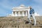 Man stands on the granite stairs at the Cathedral on the Senate