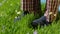 Man stands on the grass in Slippers. Male feet in sneakers on the grass