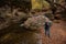 Man stands by mountain river in autumn