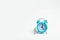 A man stands near a blue alarm clock and waits for someone. The concept of waiting for a meeting, a date. Late and punctual. The c