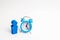 A man stands near a blue alarm clock and waits for someone. The concept of waiting for a meeting, a date. Late and punctual. The c