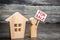 man stands near the house with a poster for sale. advertising and attracting buyers. Selling a home and real estate property