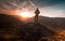 Man stands on the peak of a mountain and watching to Sun. Beautiful moment the miracle of nature