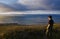 A man stands on a rock on the Arctic Coast