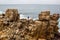 Man stands on a sea cliff, dark stormy sea on background