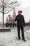 A man stands in the smart Red Square on New Years, Christmas in a funny hat