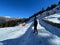 Man stands on a snowy hillside against the backdrop of majestic mountains. Chandrashila, Uttarakhand