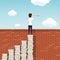 Man stands on a stack of books above a brick wall