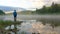 Man stands on stone against spreading fog over calm water