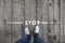 Man stands at stop message sign