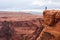 Man stands on top of a mountain. Hiker with backpack standing on a rock, enjoying valley view, Arizona