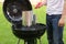 Man starting BBQ coal chimney fire with lighter