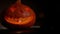 Man starts fire in Halloween Jack-o\'-lantern .Horror smile lights in the dark