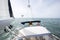 Man Steering Luxury Yacht In Sea On Sunny Day