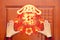 Man sticking Chinese New Year of Rabbit decoration to a door at horizontal composition translation of the Chinese word is