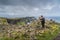 Man stone stacking in iconic Cliffs of Moher, Ireland