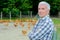 Man stood outdoors with chickens