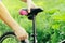 A man straightens, repairs the seat of a mountain bike on a forest road. Bicycle breakdown, vehicle repair.