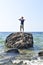 Man stranded on a rock in ocean