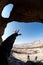 Man stretch his hand in the desert cave
