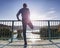 Man stretching legs before run outside within sunny morning