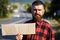 Man with strict face and beard travelling by hitchhiking