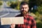 Man with strict face and beard travelling by hitchhiking