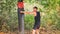 man is striking a punching bag with his left hand against the forest