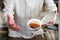 A man in stripy shirt dropping teacup with tea