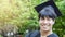 Man student smiles and feel happy in graduation gowns and cap