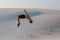 Man study parkour on their own. Acrobatics in the sand
