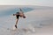 Man study parkour on their own. Acrobatics in the sand