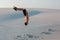 Man study parkour on their own. Acrobatics in the sand