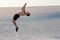 Man study parkour on their own. Acrobatics in the sand