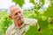 Man studying grape clusters in vineyard