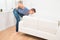 Man Suffering From Backpain While Lifting Sofa