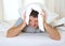 Man suffering hangover and headache with pillow on