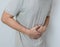 Man suffering from stomach ache with both palm around waistline to show pain injury on belly area