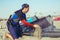 Man sufrers in wetsuits with kite equipment