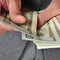 Man in suit with counting dollar bills