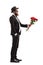 Man in a suit giving a bouquet of red roses