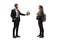 Man in a suit giving soccer ball to a female student