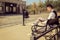 Man in suit with glasses and whiskers reading book in the old town