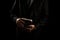 Man in suit holding a bible in his arm on a black background. AI generated