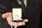 Man in suit holding engagement ring