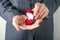 Man in suit holding engagement ring