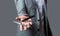 Man in a suit holds in his hand a vintage razor and scissors. Male in barbershop. Barber scissors and straight razor