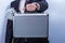 Man in suit holds metal briefcase with dollars