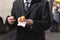 Man in a suit with a hotdog