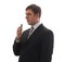 A man in a suit says in a digital voice recorder.